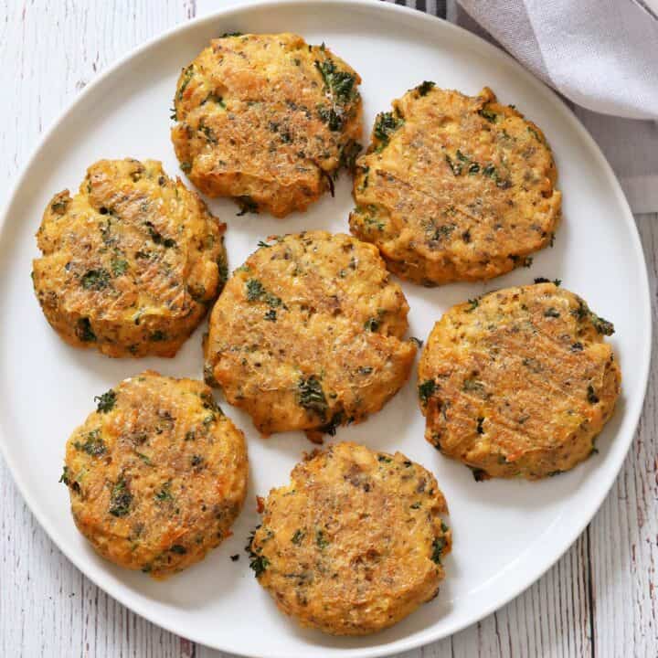 Baked salmon cakes are served on a white plate.