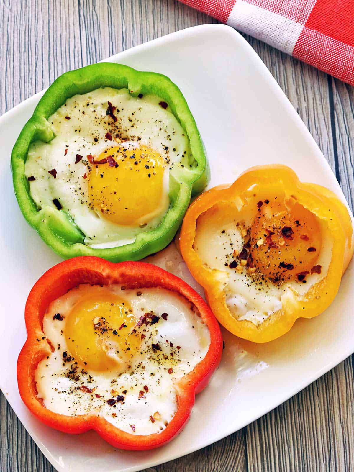 Bell pepper eggs are served on a white plate.