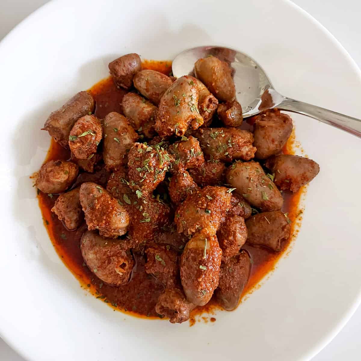 Chicken hearts are served in a bowl.