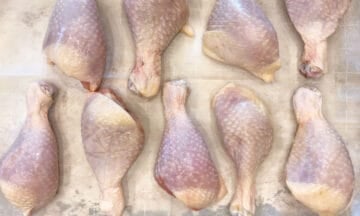 The drumsticks are arranged on a baking sheet.