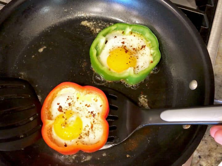 Lifting the peppers from the skillet.
