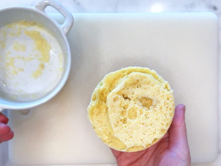 Removing the muffin from the ramekin.