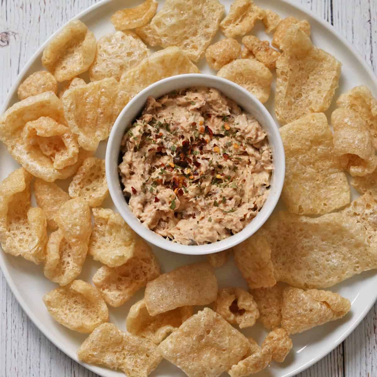 The salad is served with pork rinds.