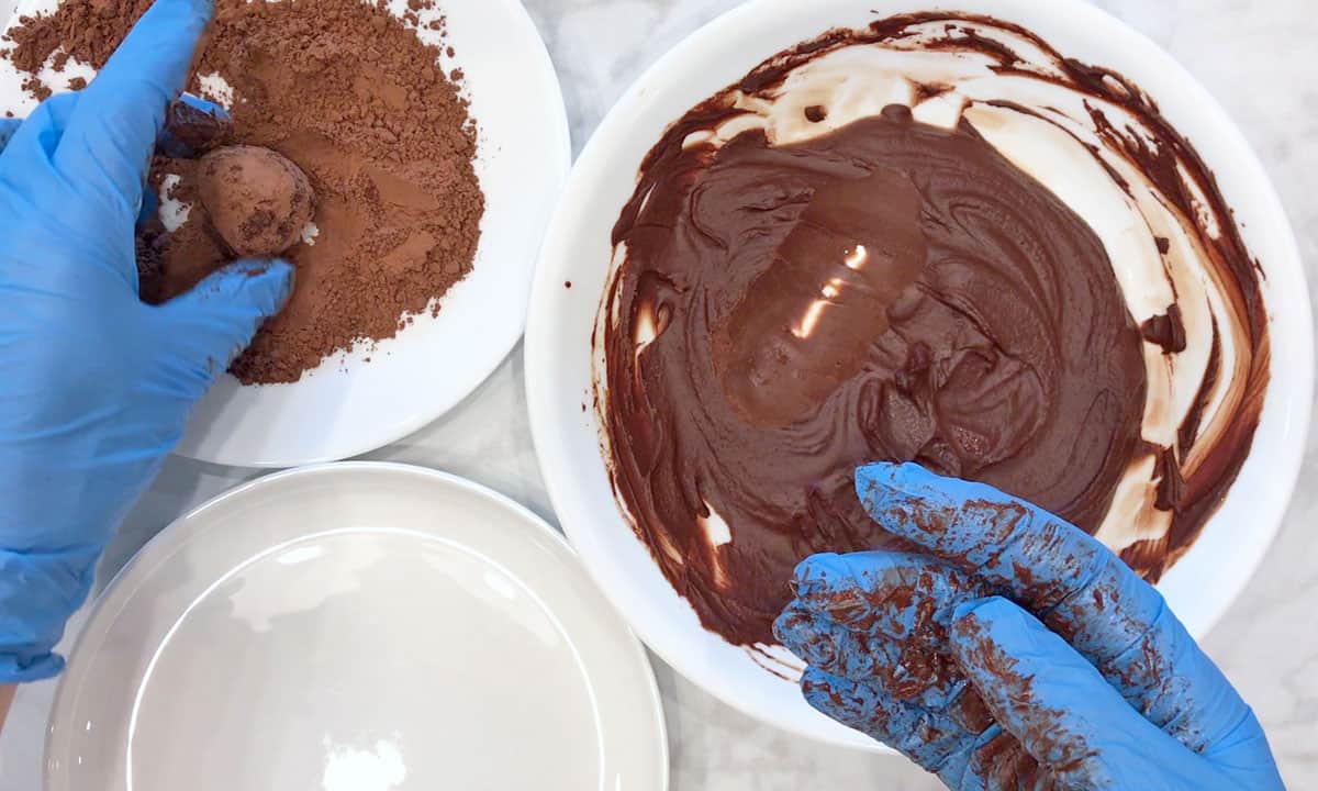 Shaping the truffles and coating them in cocoa powder.