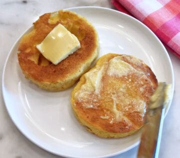 Topping the muffin with butter.