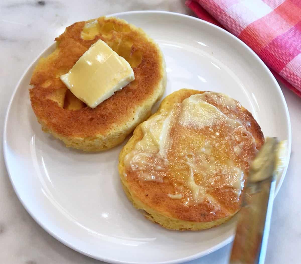 Topping the muffin with butter.
