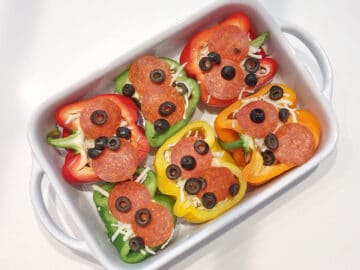 Topping were added to the peppers - pepperoni and olives.
