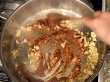 Adding the seasoning paste to the skillet.