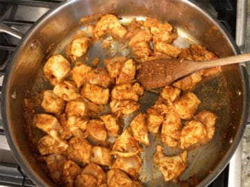 Coating the chicken in the seasoning paste.