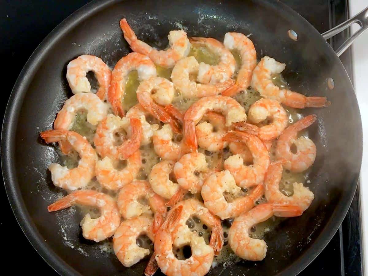 Cooking the shrimp in butter.