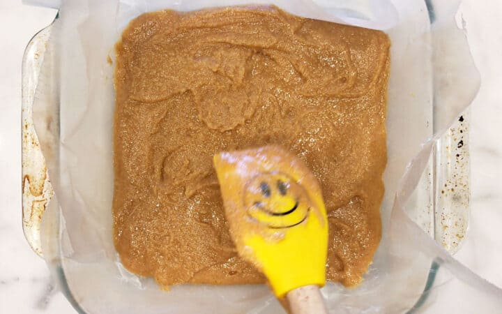 Spreading the bottom layer in the pan.