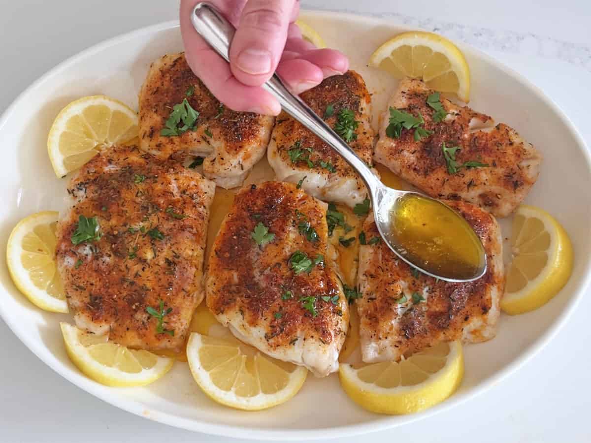 Pouring brown butter sauce on the fish.