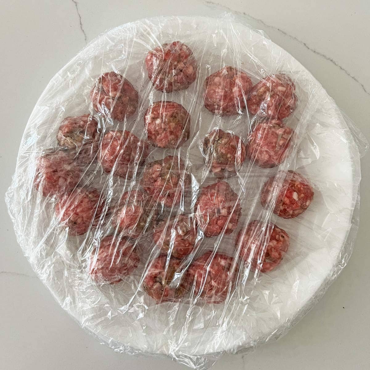 The shaped meatballs were covered in cling wrap.