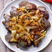 Chicken liver is topped with onions.