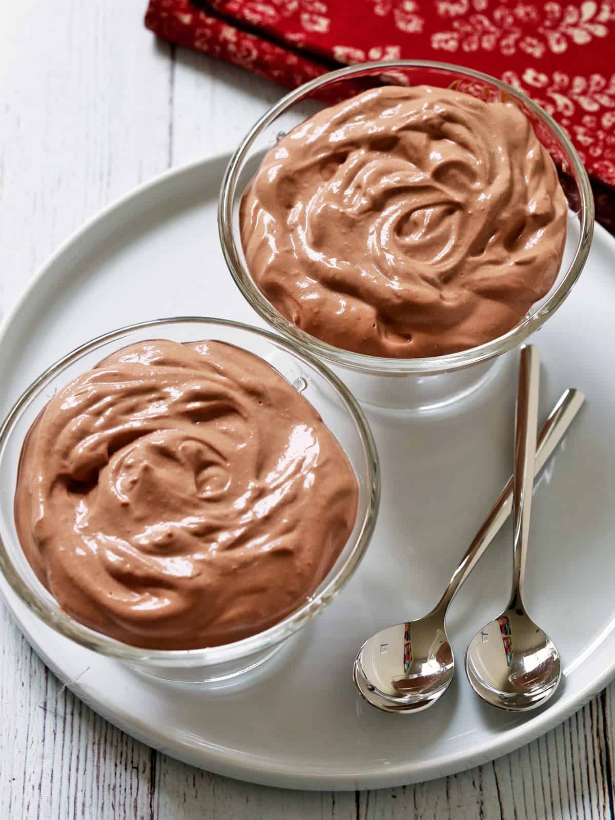 Cottage cheese chocolate mousse is served in two dessert glasses.