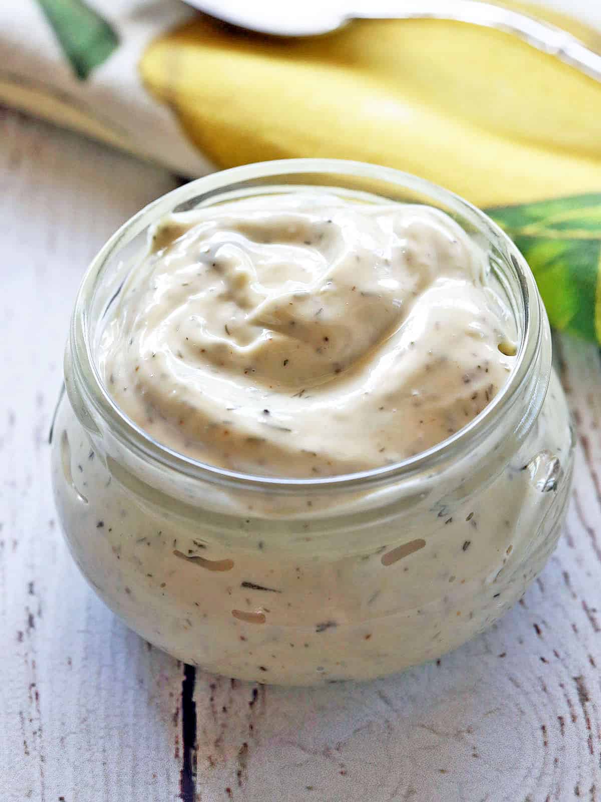 Homemade tartar sauce is served in a small glass jar.
