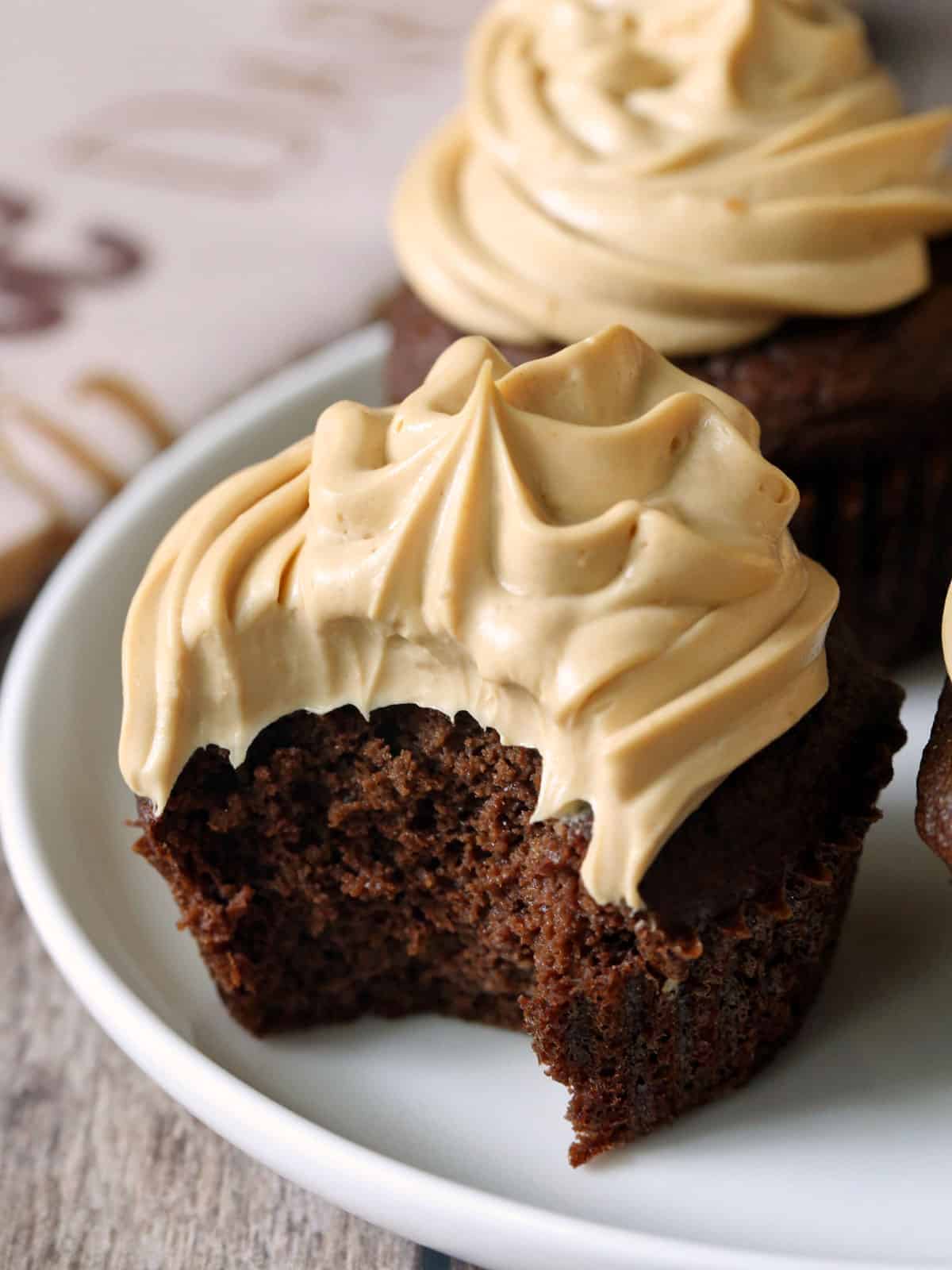 Keto chocolate cupcakes are served on a white plate.