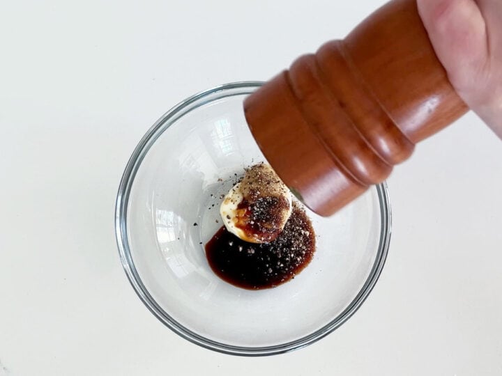 Adding the dressing ingredients to a bowl.