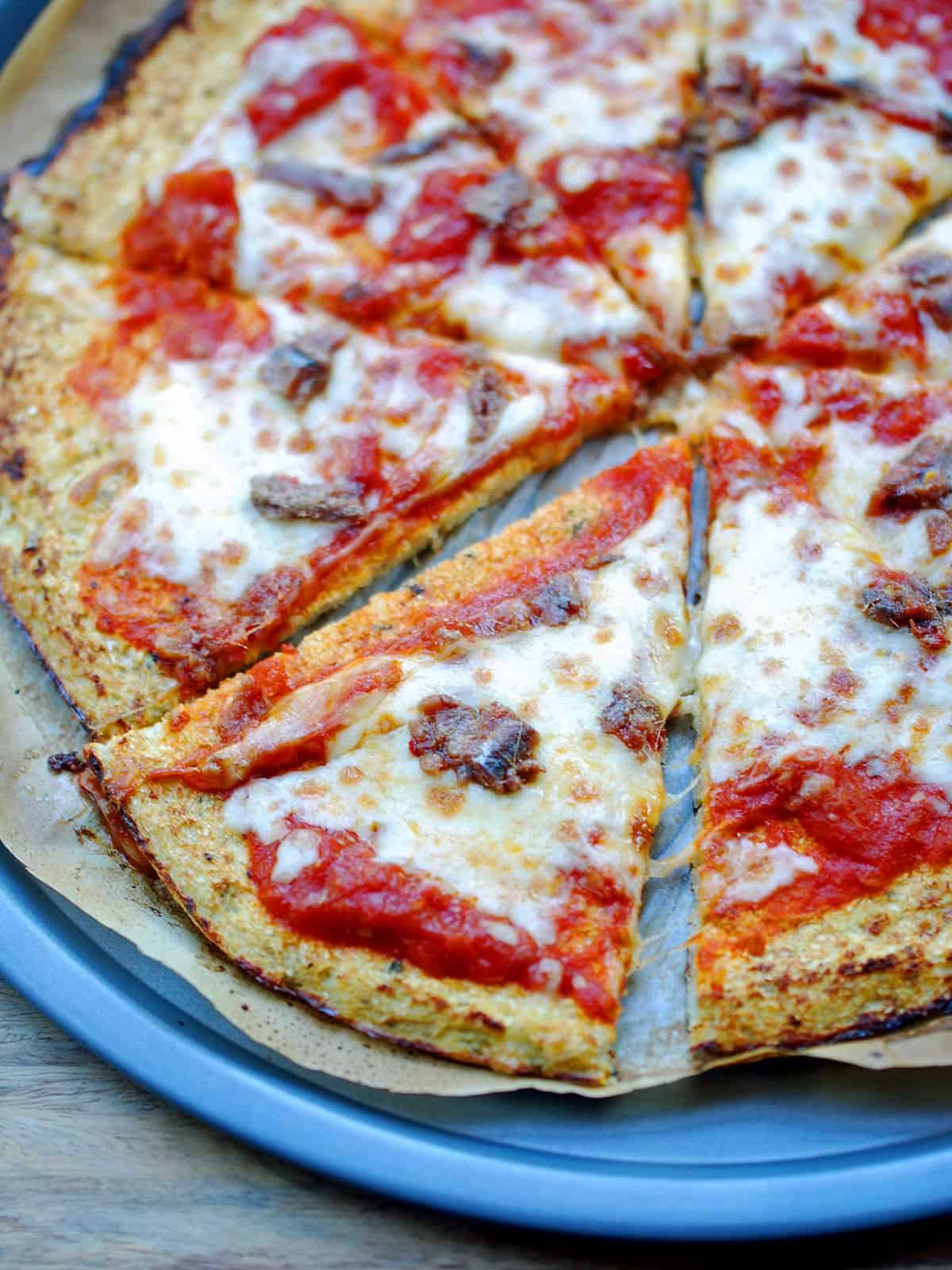 Pizza made with a cauliflower crust is topped with anchovies.