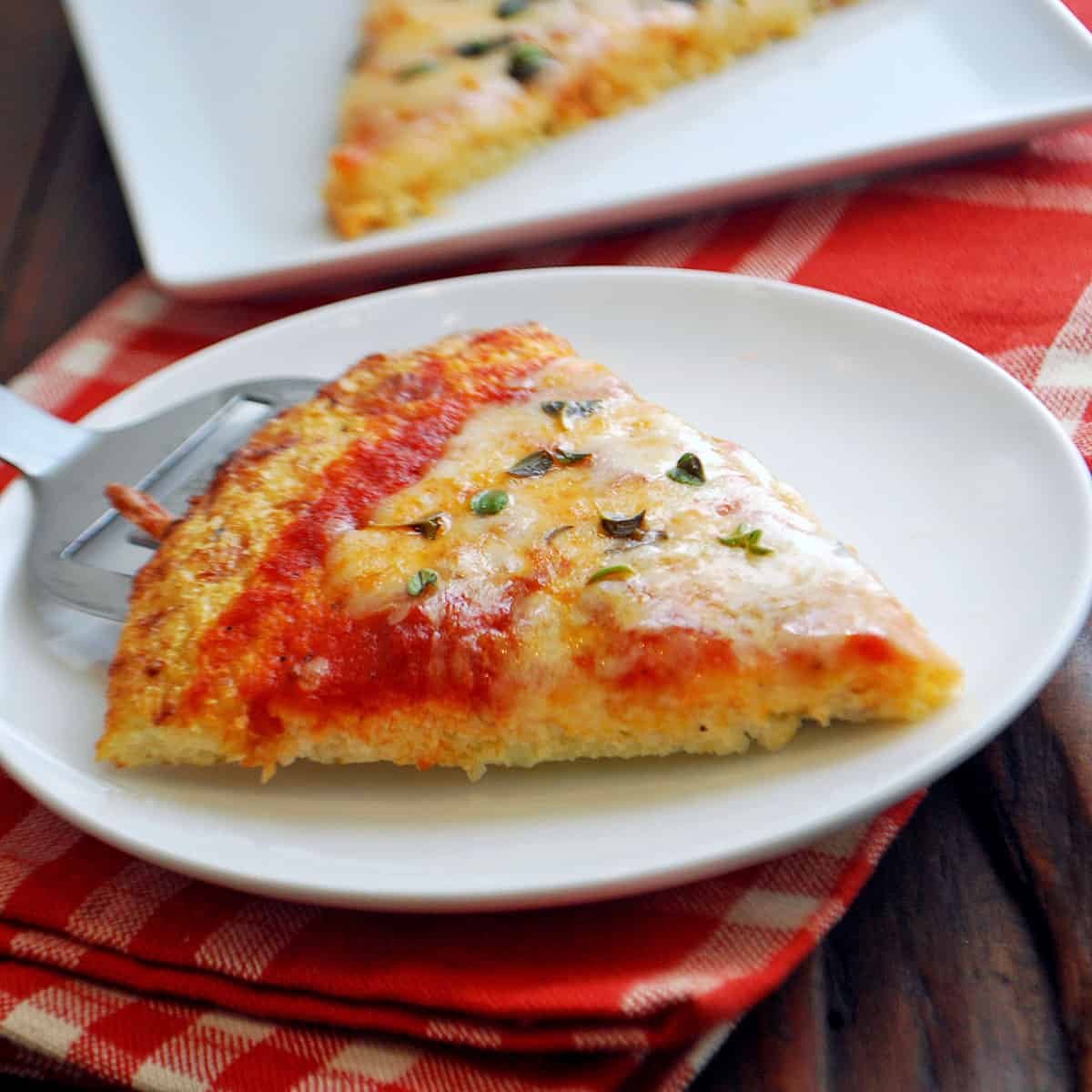 A slice of pizza made with cauliflower crust.