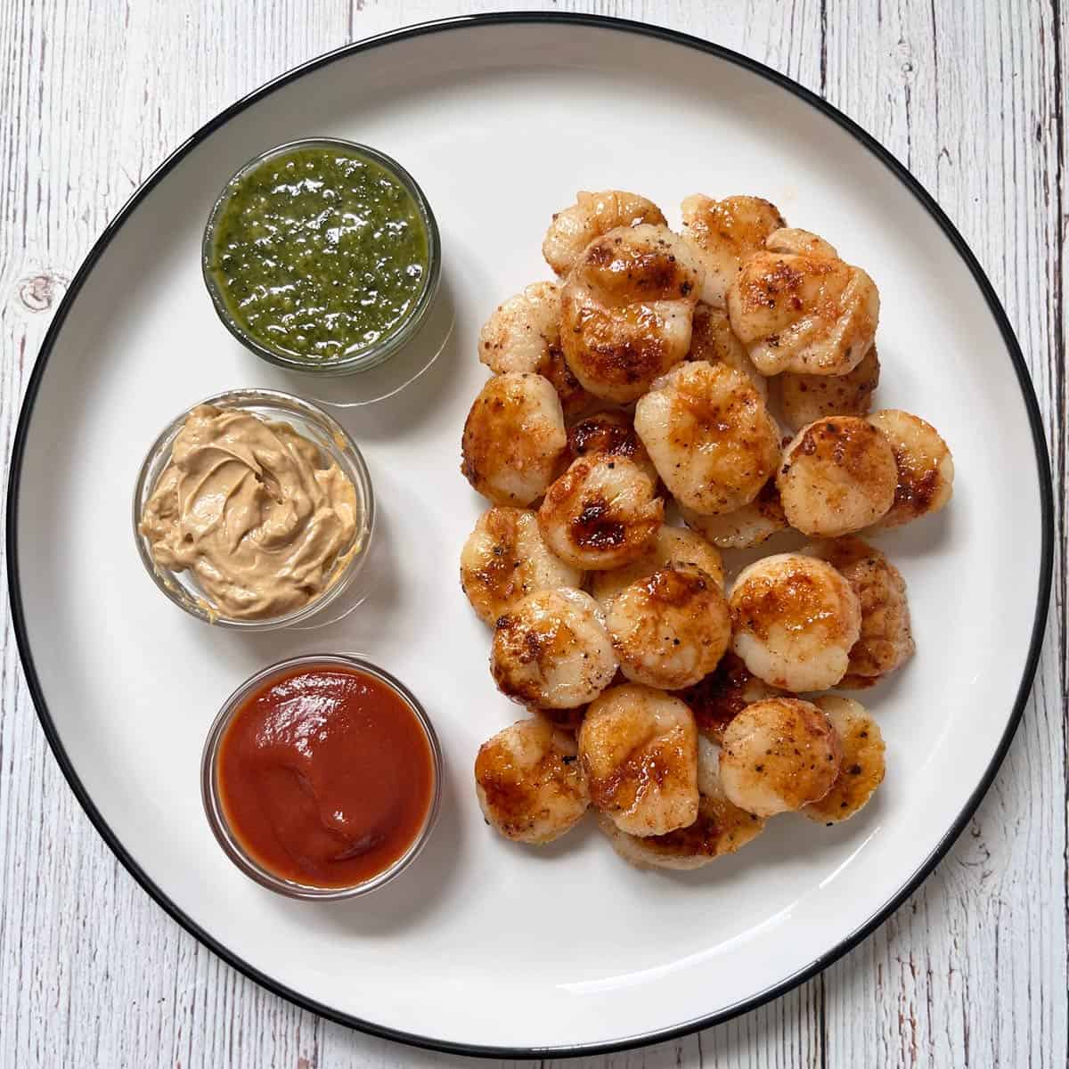 Cold leftover scallops are served with dips.