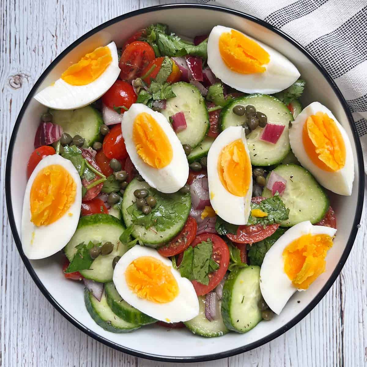 Cucumber tomato salad with added eggs.