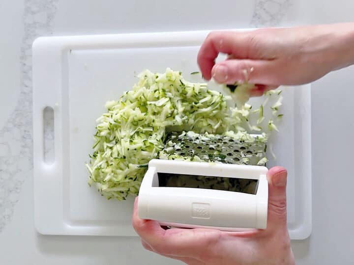 Grating the zucchini.