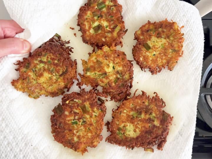 Draining the fritters on paper towels.