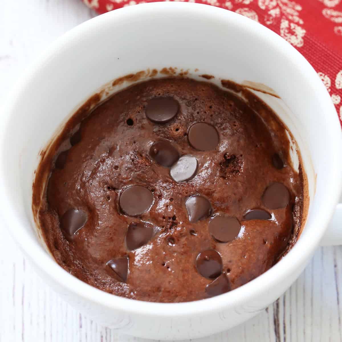 A chocolate mug cake with added chocolate chips.