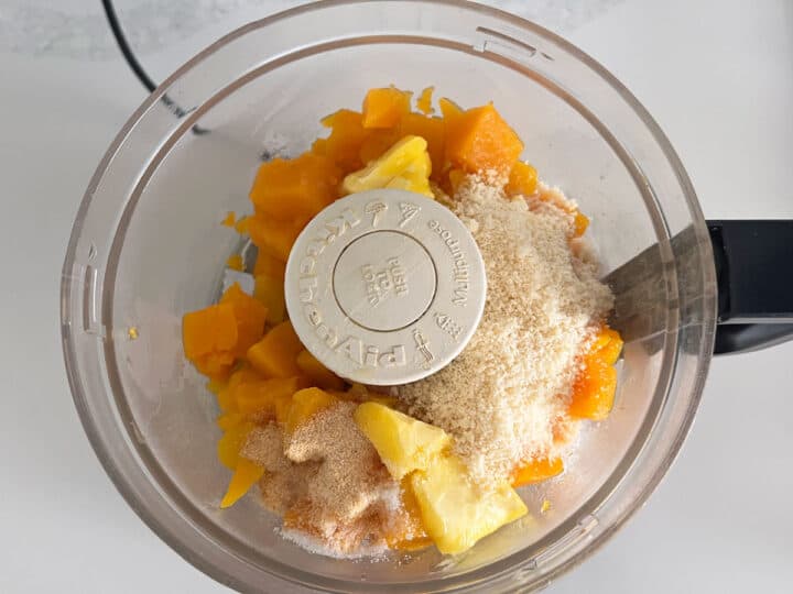 The squash and other ingredients were added to the food processor's bowl.