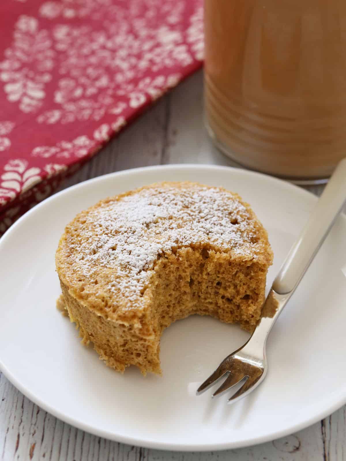 Keto mug cake is served with iced coffee.