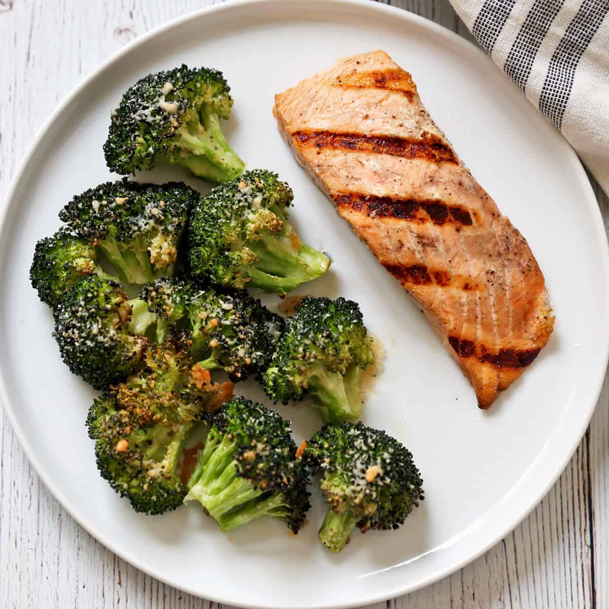Parmesan-roasted broccoli is served with grilled salmon.