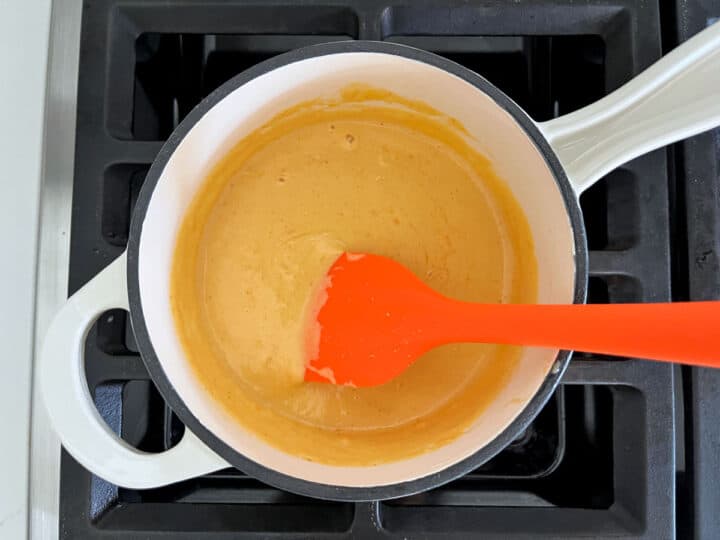 The cheese sauce is ready in the saucepan.