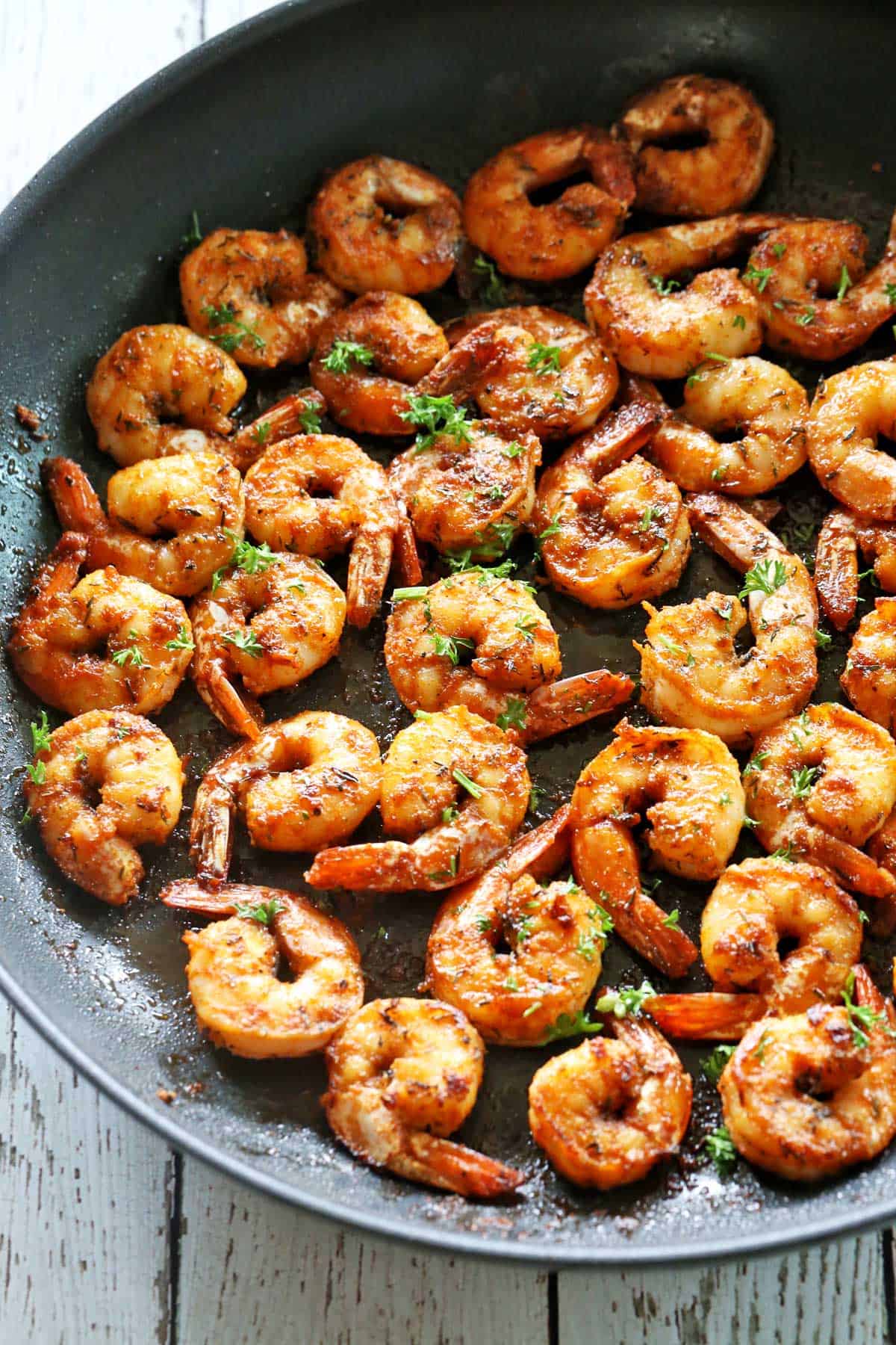Sauteed shrimp in a skillet.