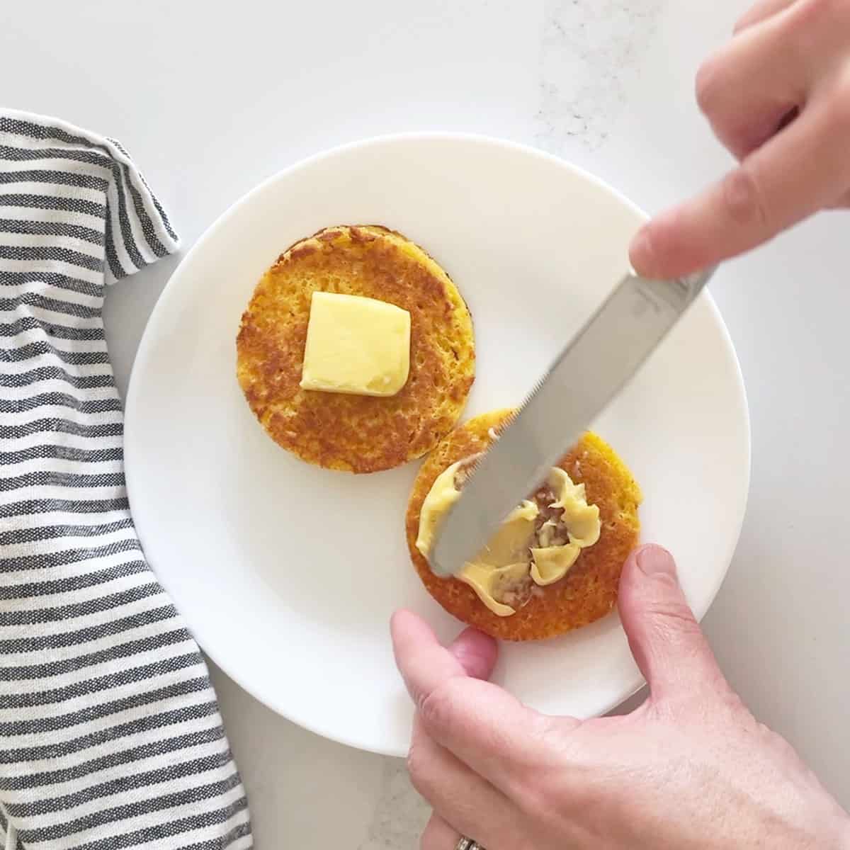 Spreading butter on the bread.