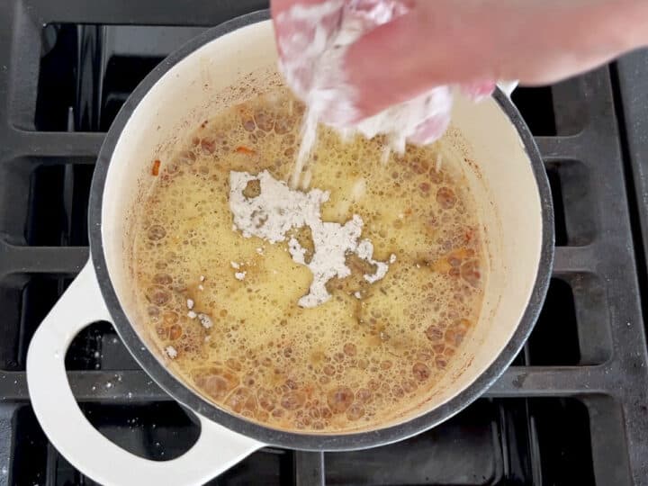 Adding flour to the saucepan.