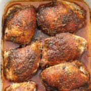 Cajun chicken in a white baking dish.