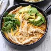 Chicken chili is served in a bowl with a napkin.