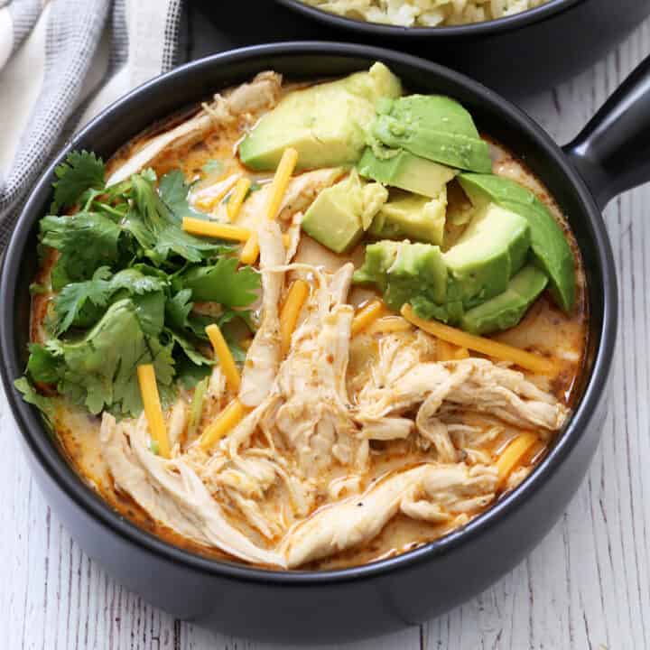 Chicken chili is served in a bowl with a napkin.