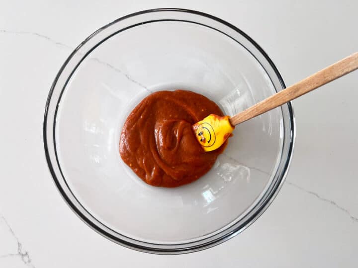 Mixing buffalo sauce in a bowl.