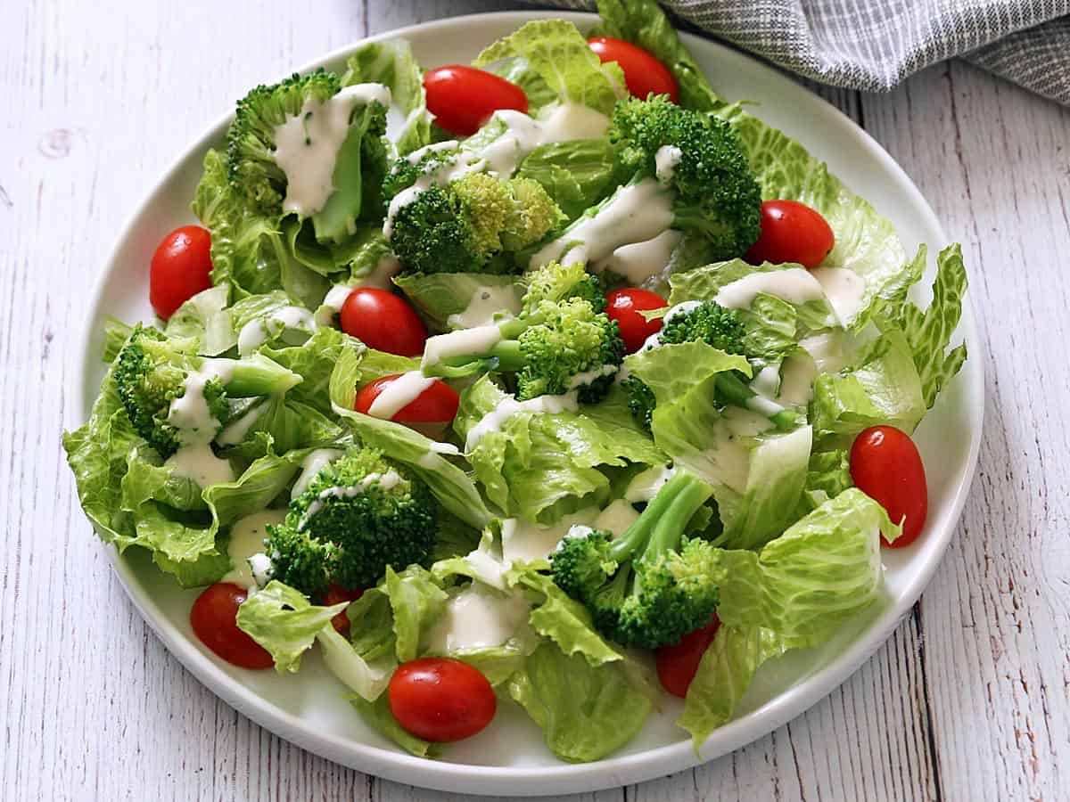 Steamed broccoli leftovers are used in a salad.