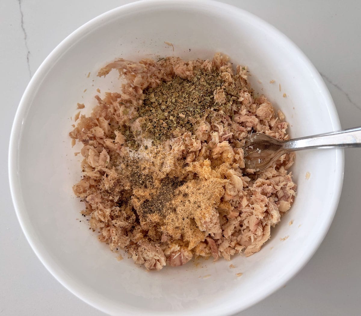 The salmon is seasoned with dry spices.