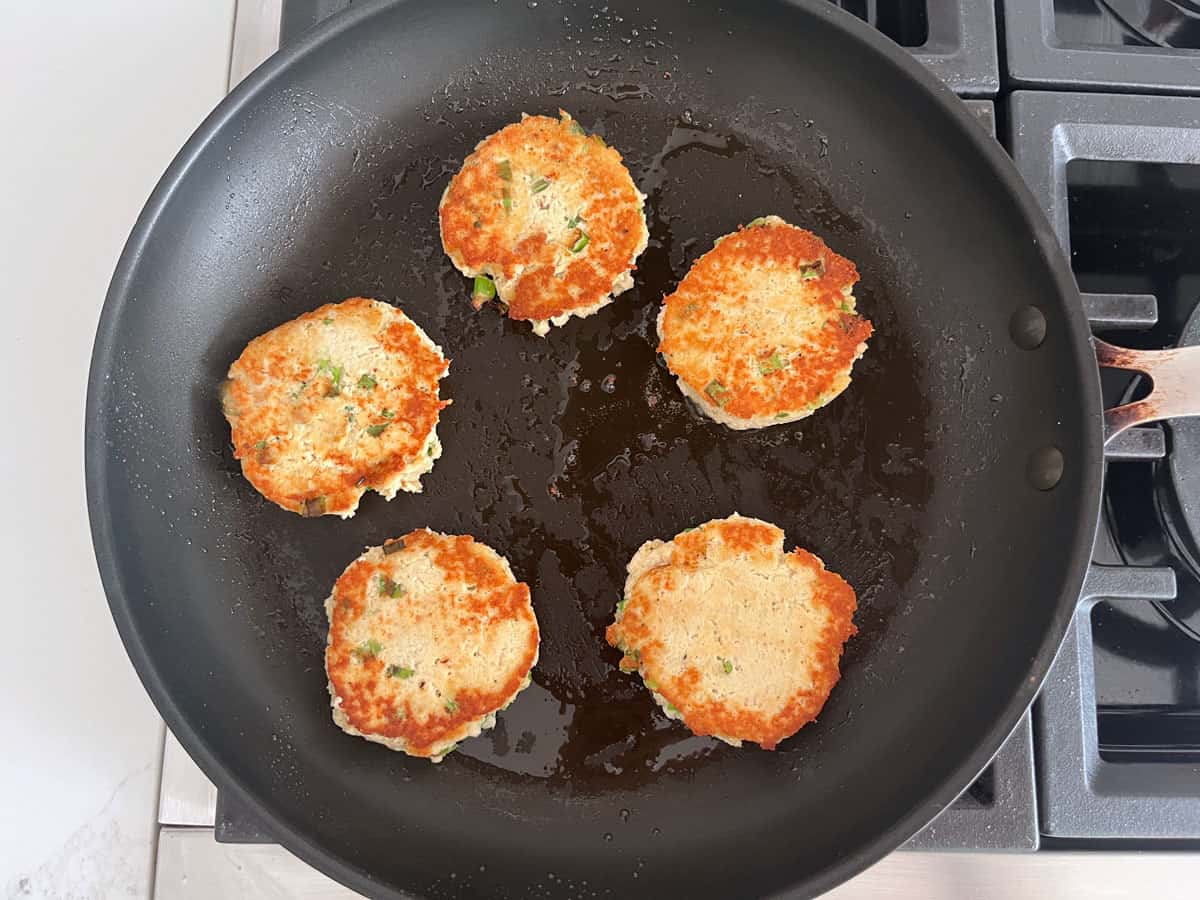 Cooking leftover turkey patties in a skillet.