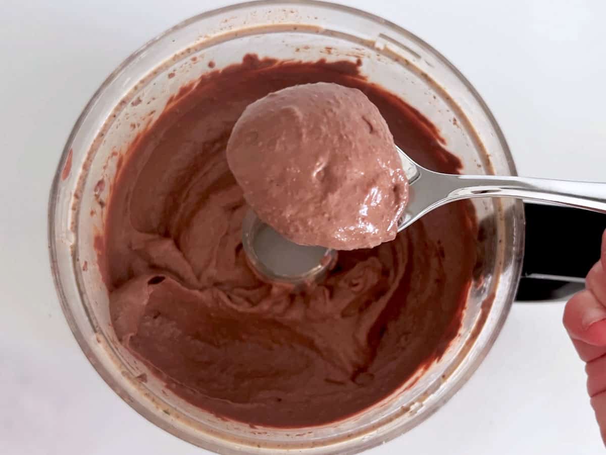 A spoon showing how light and fluffy the mixture is.