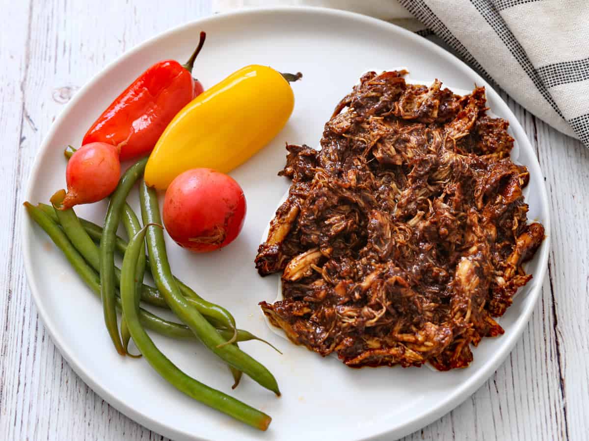 Quick pickles are served with pulled chicken.