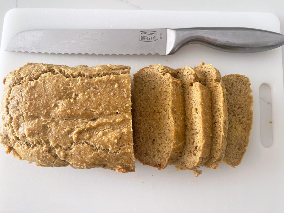 The bread was sliced on a cutting board.