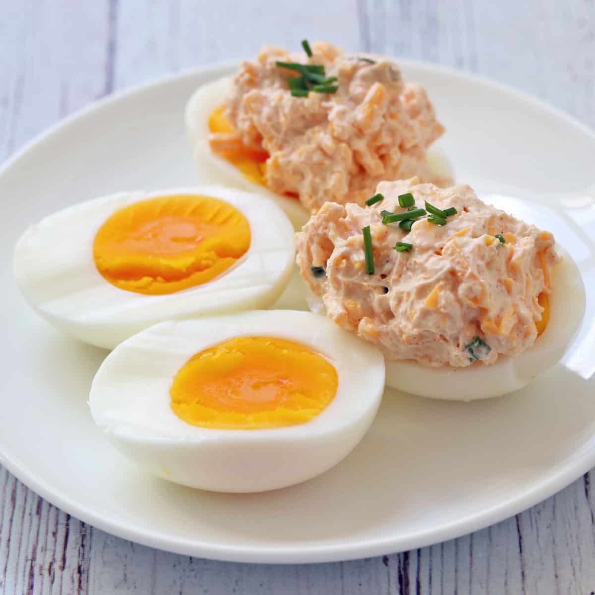 Hard-boiled eggs are topped with cream cheese dip.