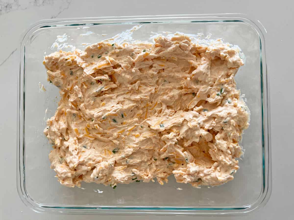 Cream cheese dip is stored in a glass container.