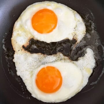 Two fried eggs in a skillet.