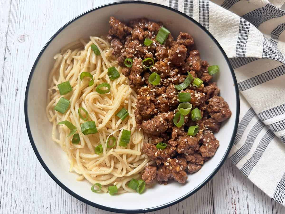 Korean ground beef is served with noodles.